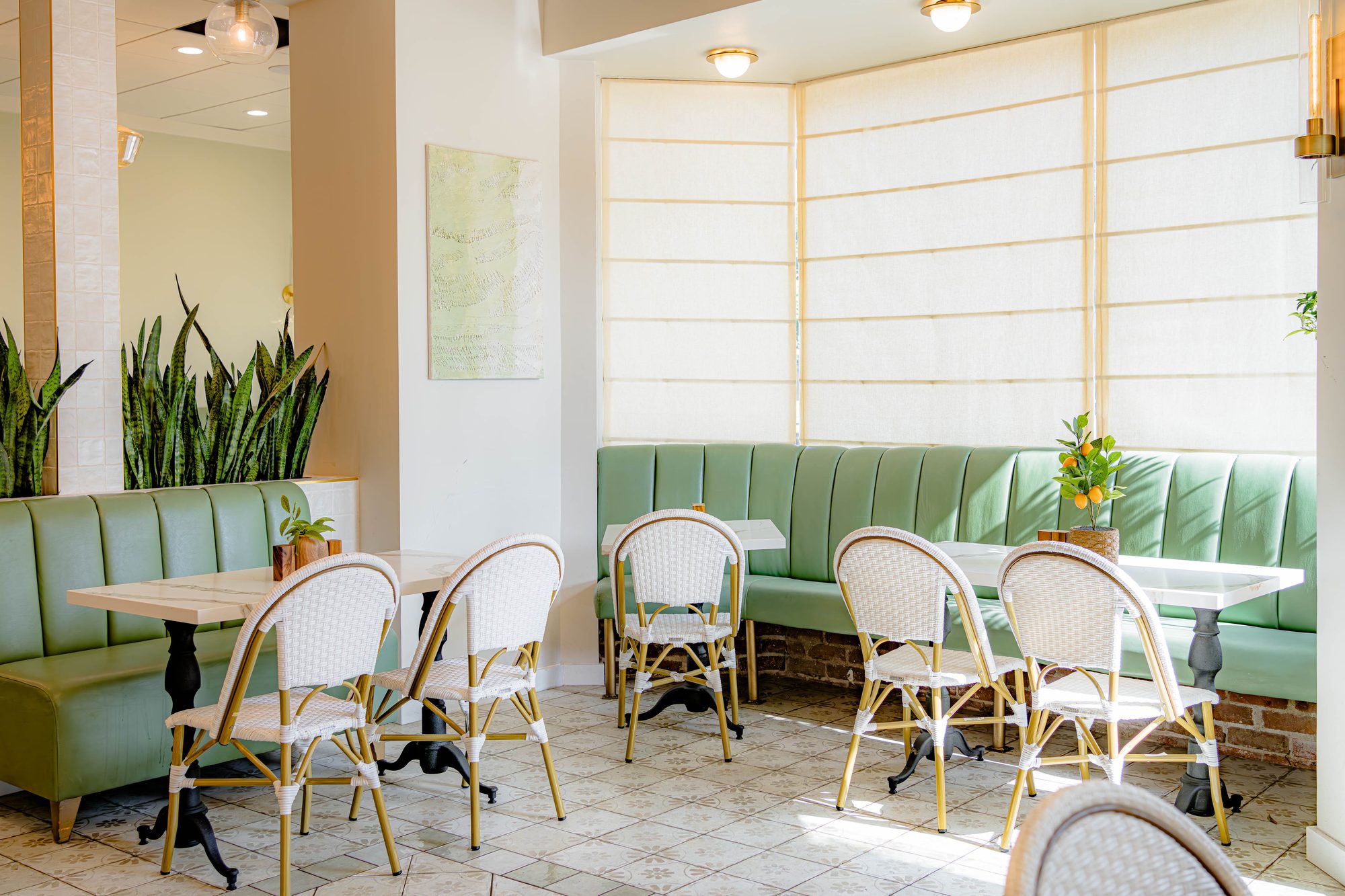 Lamalo café dining room with sage green banquettes designed by NOF DESIGN